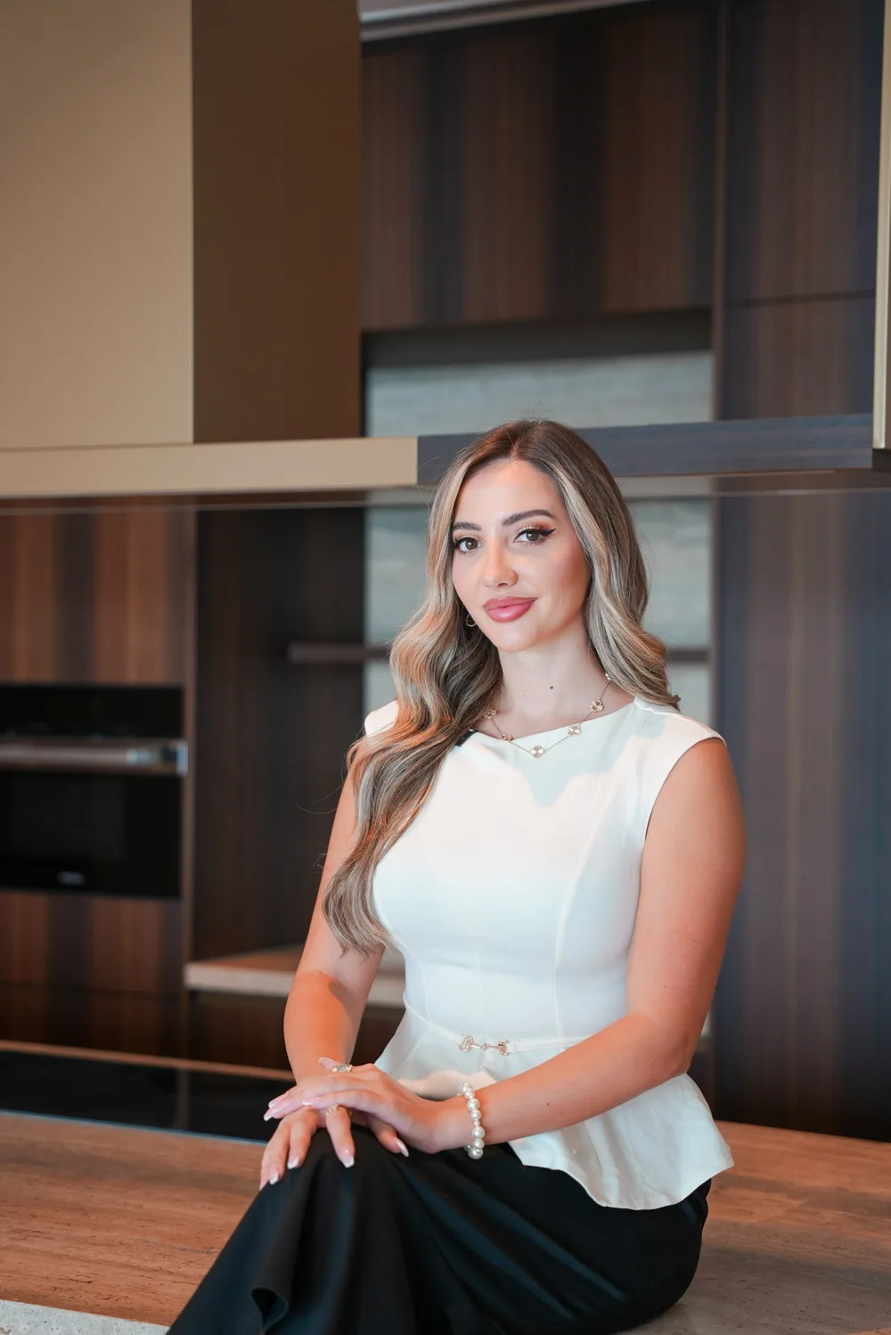 Andrea Jiga seated in a residence kitchen